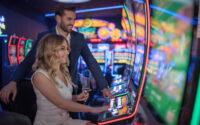 handsome couple having fun and drinking wine at casino